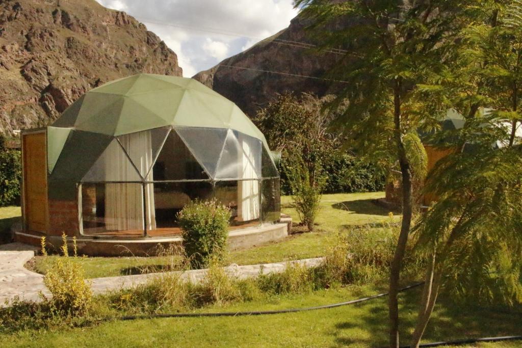 a small dome house in a field of grass at Sky Domos Pachar in Pachar