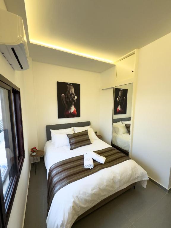 a bedroom with a large bed with a towel on it at Railway studio 3 - Luxury Suite in Byblos - Central & Relaxing in Jbeil