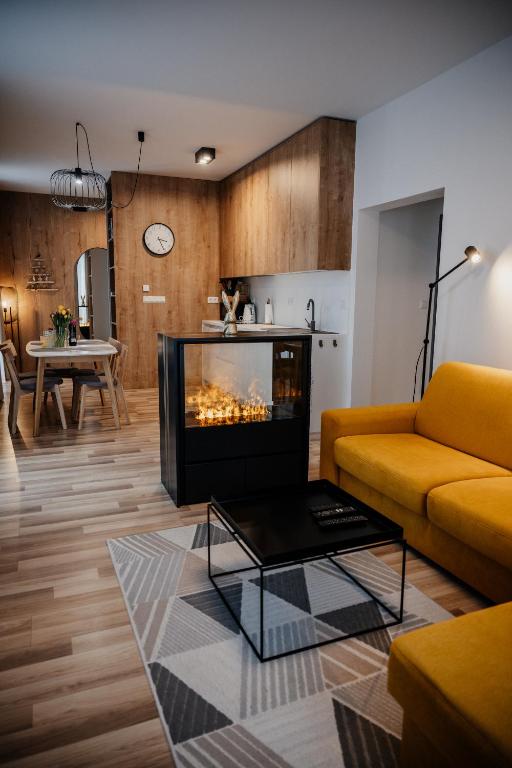 a living room with a couch and a fireplace at Apartmány Esprit in Dolný Kubín