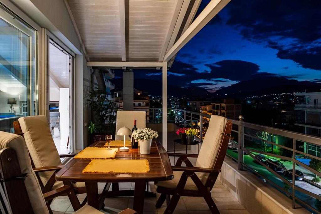 a table on a balcony with a view of the city at Gela in Livadeia