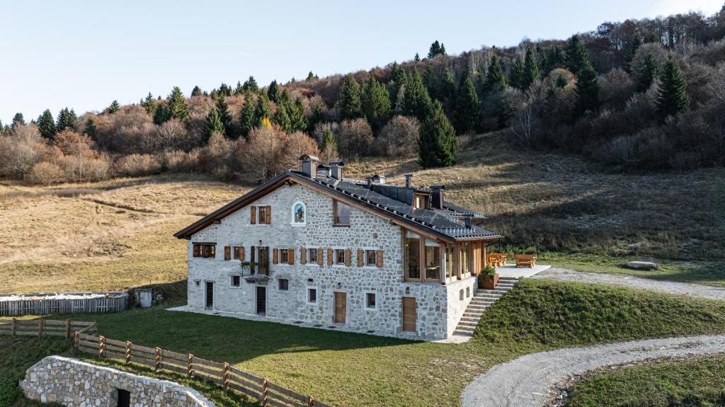 an aerial view of a large stone house on a hill at Chalet Brento in Lundo