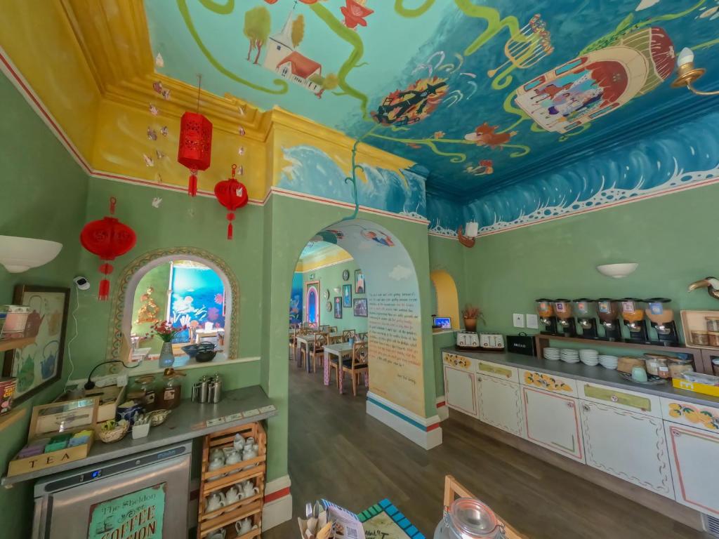 a restaurant with a room with a ceiling with dinosaurs on it at The Sheldon B&B in Eastbourne