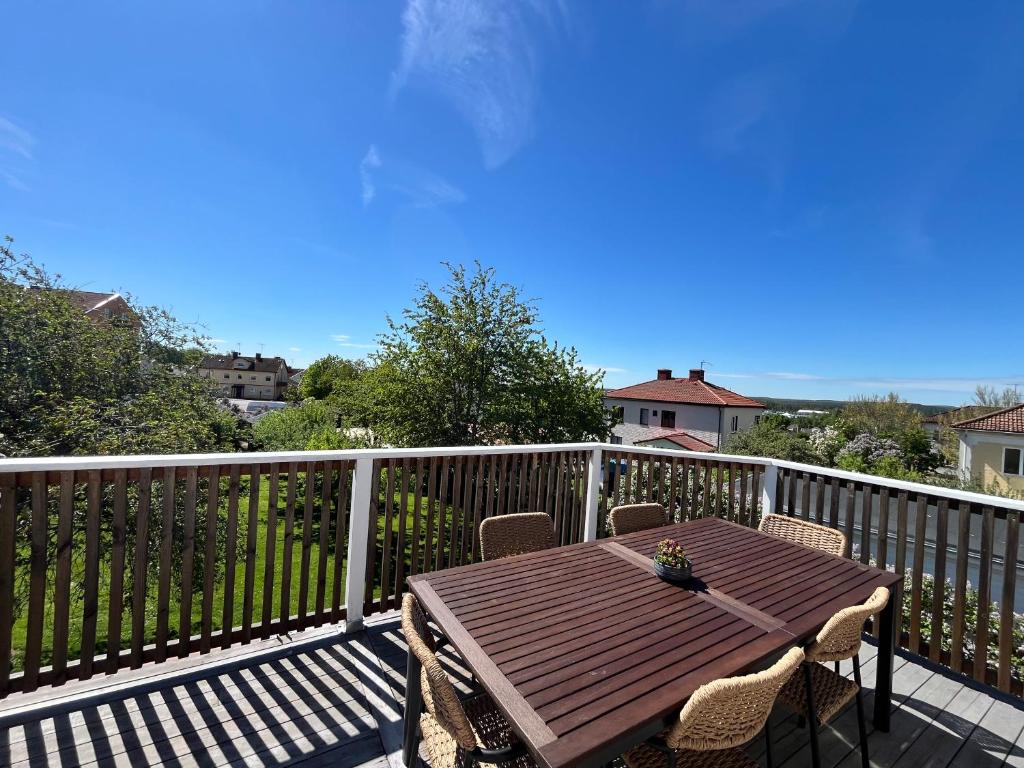 a wooden table and chairs on a deck at Villa Lindäng Apartment -Vimmerby in Vimmerby