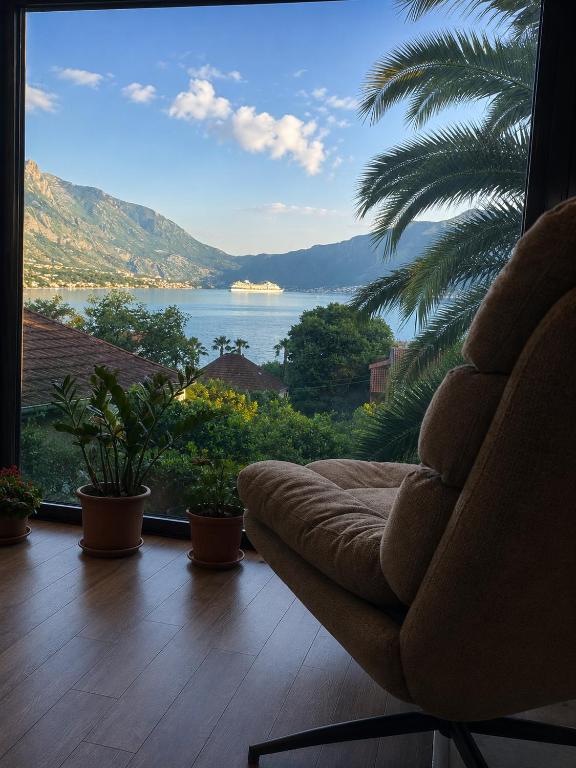 a couch sitting in front of a large window at Meditation in Kotor