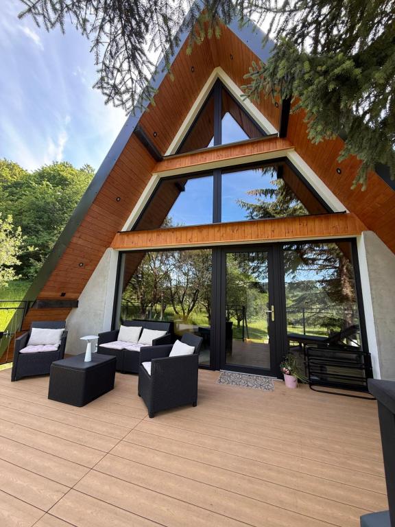 a building with a patio with couches and windows at Chalet Tri pramene in Moravské Lieskové