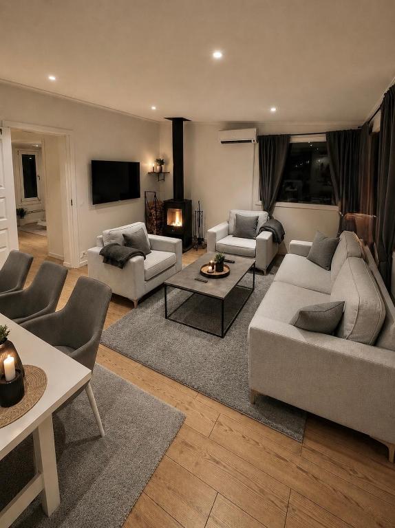 a living room with two couches and a tv at Mysig stuga i Nävesta in Örebro