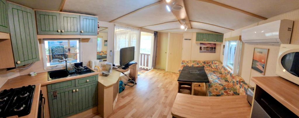 a kitchen and living room of an rv at Evasion Charente in Sémussac