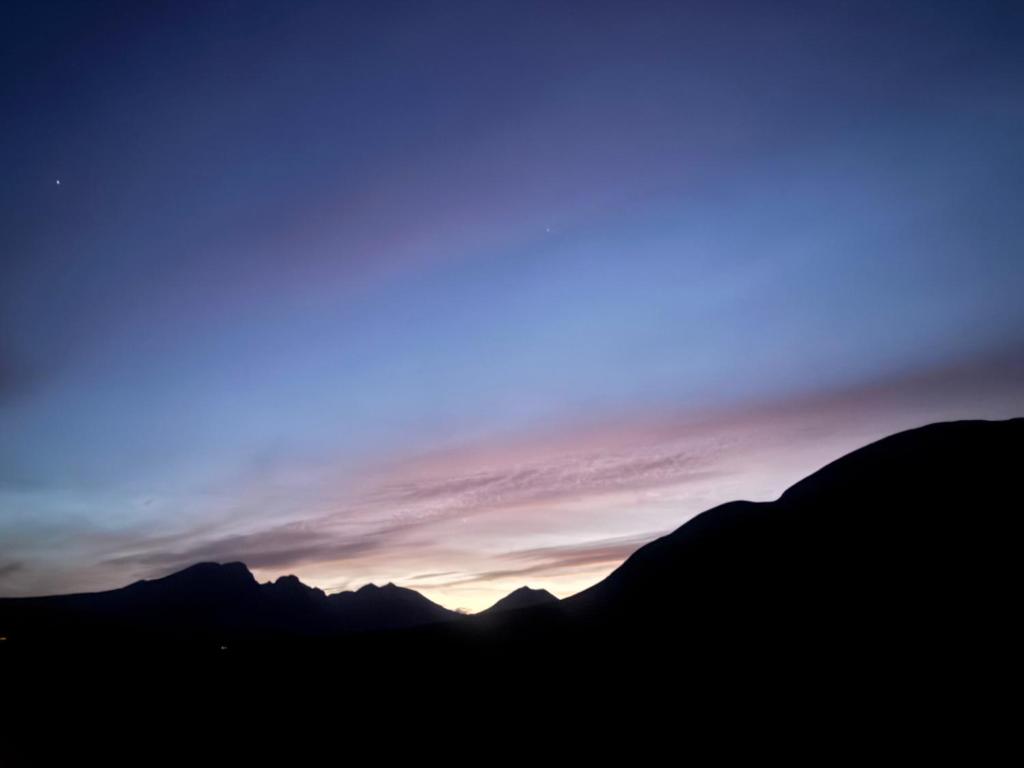 a view of the sunset over the mountains at Laimhrig Lockley in Torrin