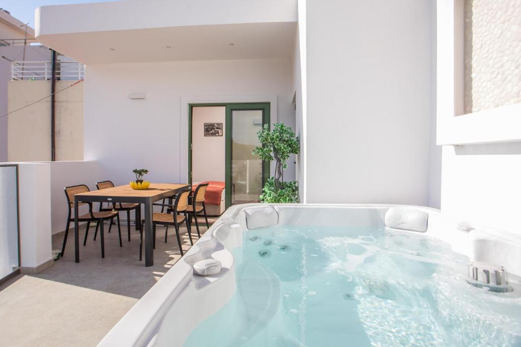 a bath tub in a room with a table at Aegora Residence in Kalithies