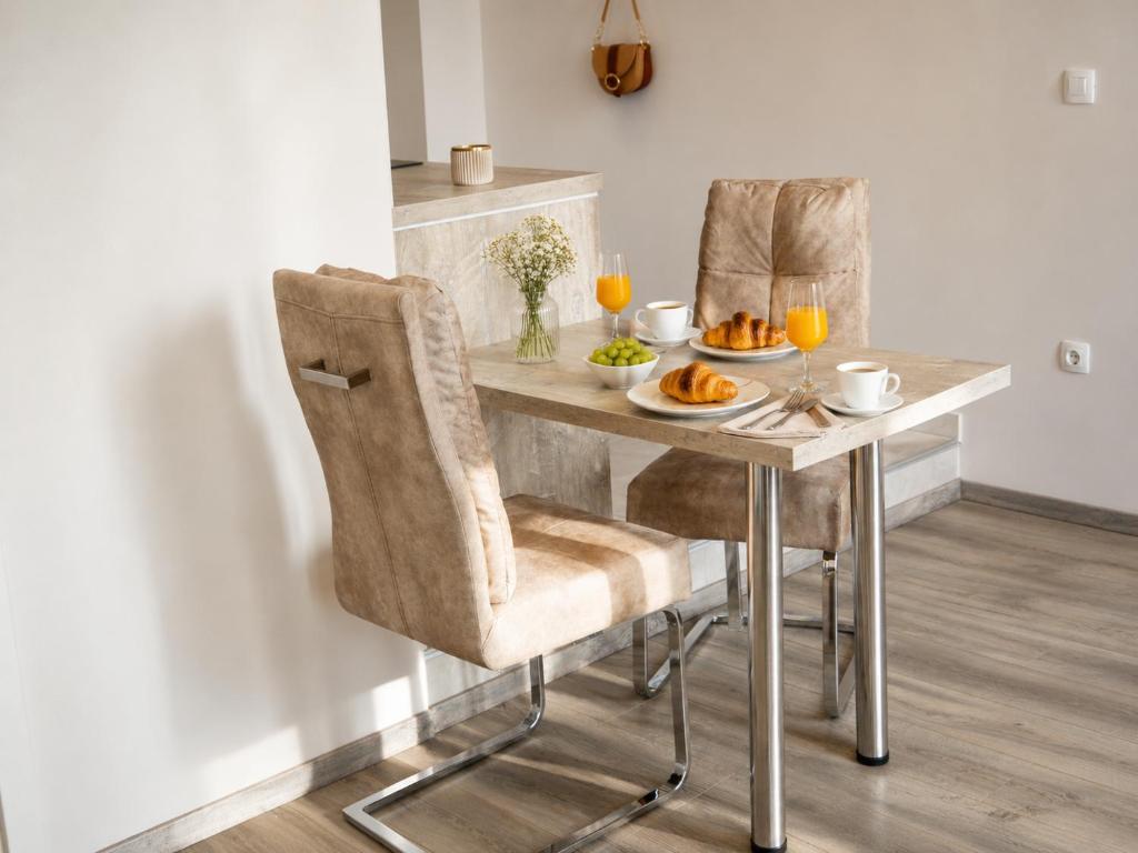 a dining room table with two chairs and food on it at Center Vibes Lux in Rijeka