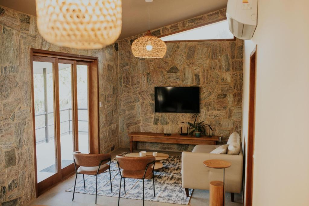 a living room with a couch and a tv at Villa Arouca in Areal