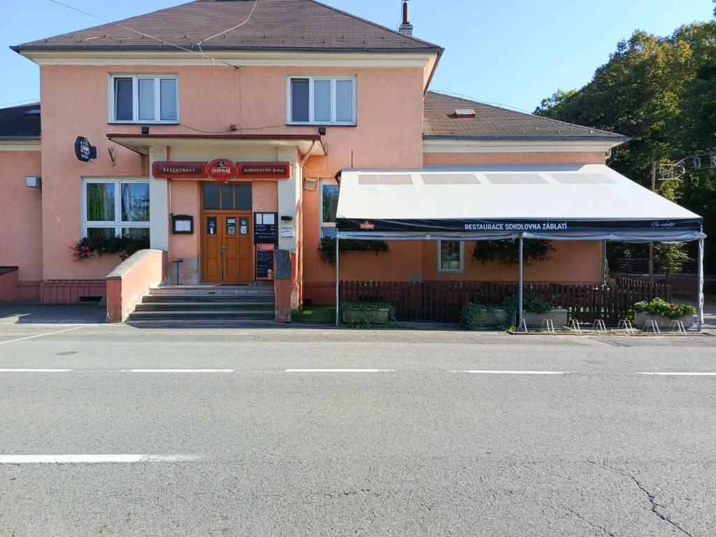 a building with a white awning in front of it at Sokolovna in Bohumín