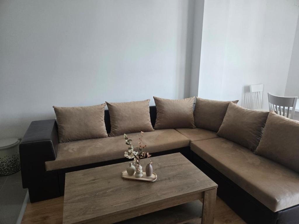 a living room with a brown couch and a coffee table at Artea Hisarya in Hisarya