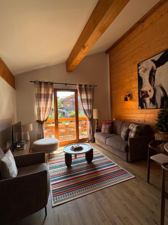 a living room with a couch and a table at Maison MAEL in Notre-Dame-de-Bellecombe
