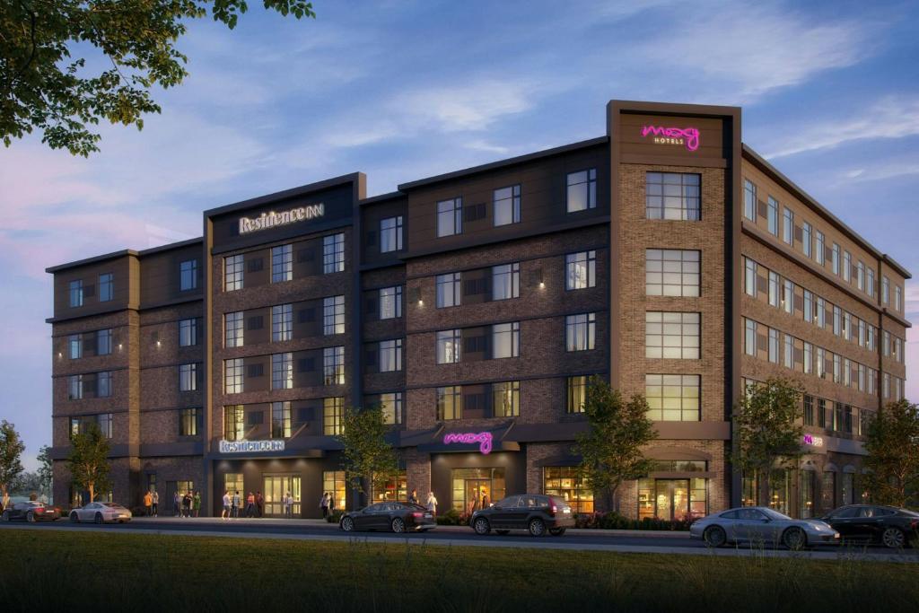 a rendering of an apartment building with cars parked outside at Moxy Portland Thompson's Point in Portland