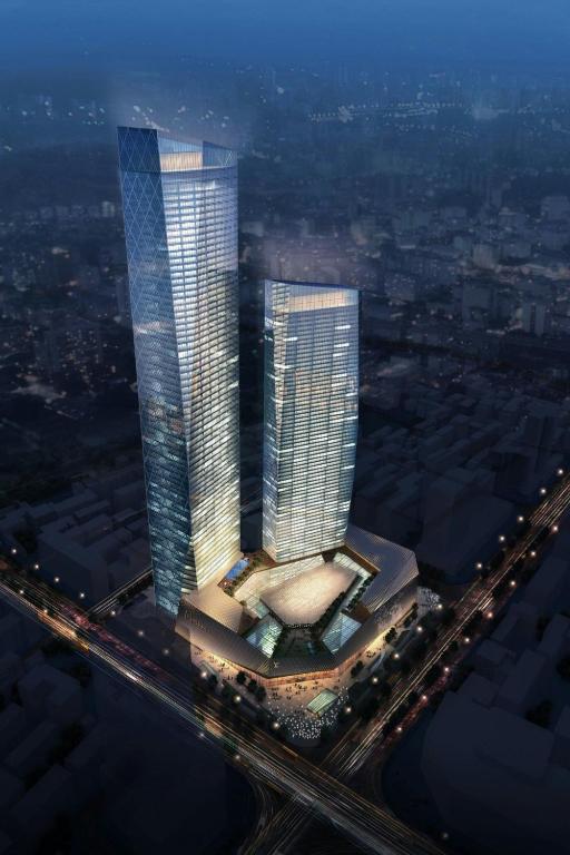two tall skyscrapers in a city at night at Zhenjiang Marriott Hotel in Zhenjiang