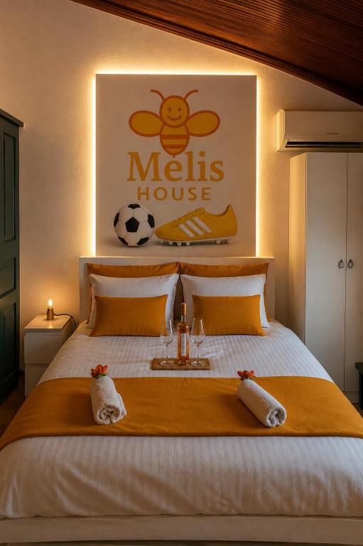 a bedroom with a bed with a soccer ball on the wall at Melis House - Lake View, 75'' TV Live Football, Free Parking in Ioannina