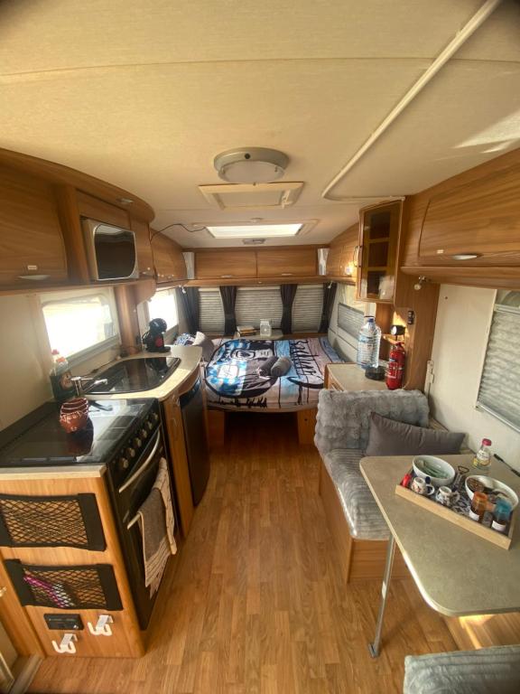 an aerial view of a kitchen and living room in an rv at Little Hideaway Deluxe in Costa da Caparica
