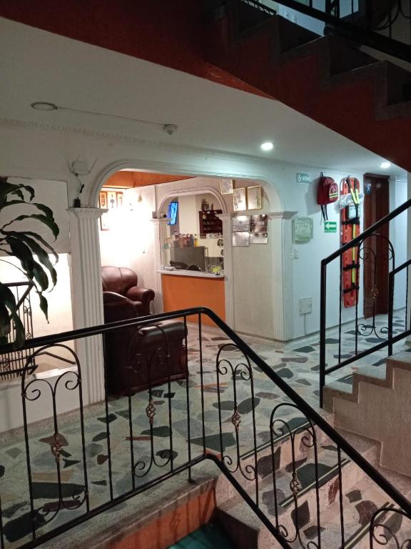 a staircase in a house with a living room at Hotel Manhattan City in Duitama