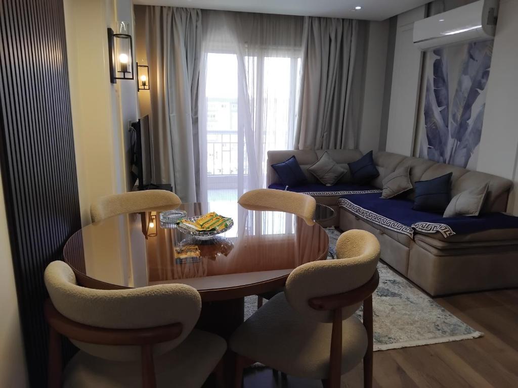 a living room with a table and chairs and a couch at Dar Residence - Madinaty B12 - U2 - 2 BR - New Cairo in Madinaty