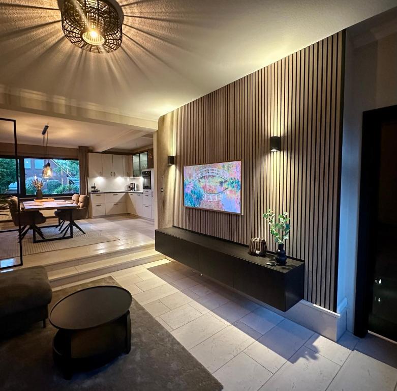 a living room with a flat screen tv on a wall at Ferienwohnung Marina in Wiesmoor