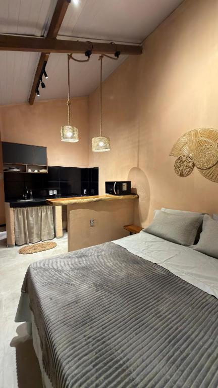 a bedroom with a large bed and some lights at Guajiru Beach House KiteSurf in Trairi
