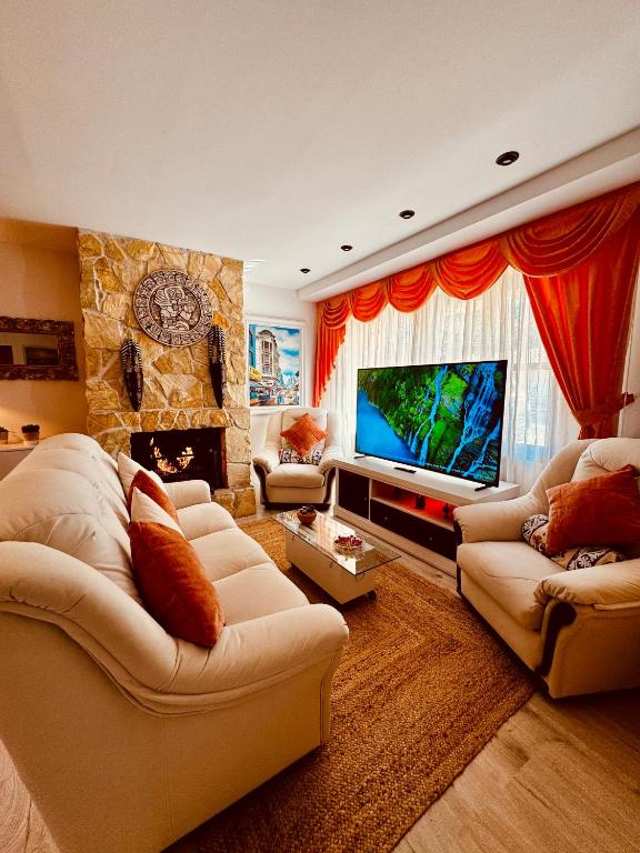 a living room with two couches and a television at Villa Alexandra 1 in Imárcoain