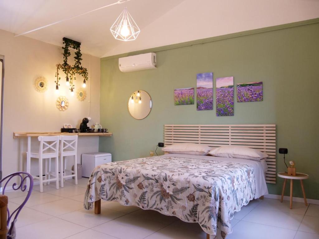 a bedroom with a bed and a table in it at Chicche di Lavanda in Valmadonna