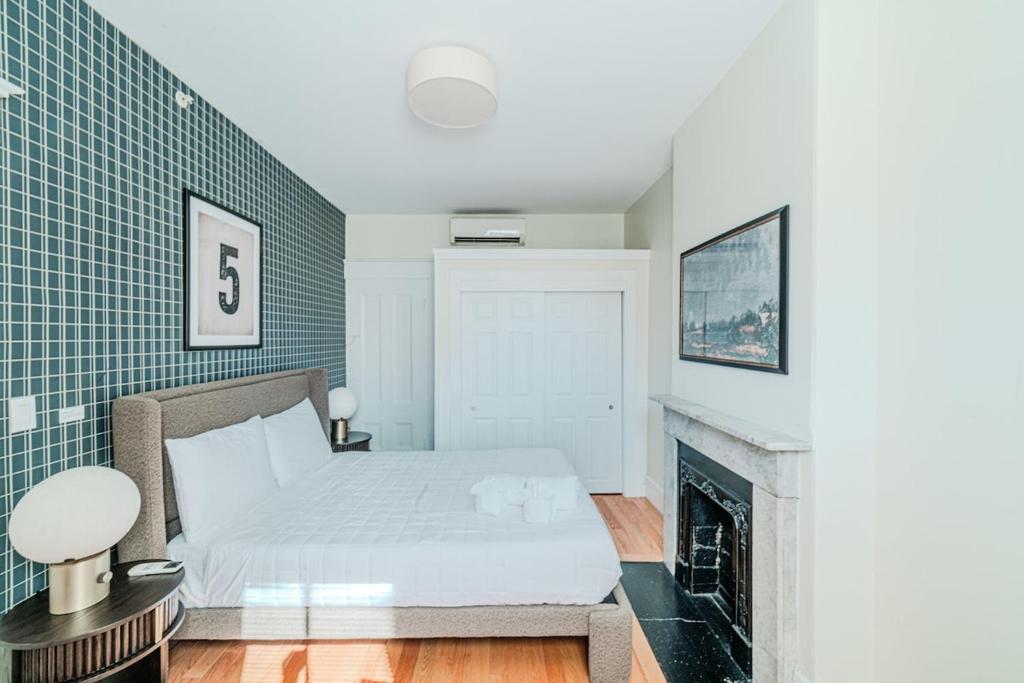 a bedroom with a bed and a fireplace at Beacon Hill Nights in Boston