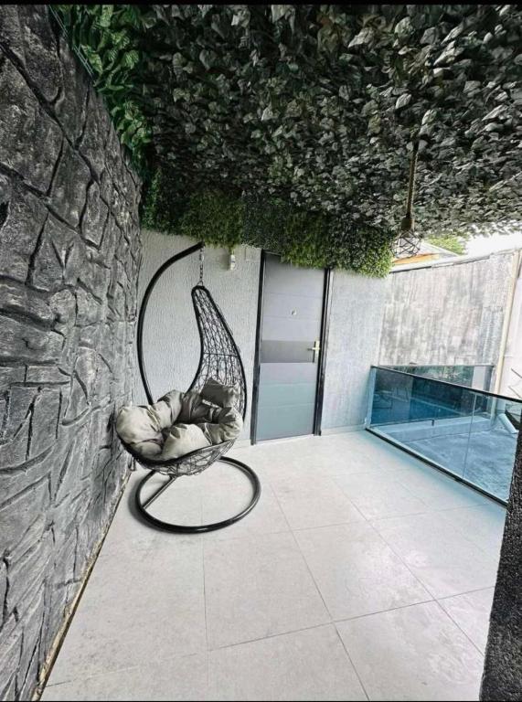 a chair sitting on a patio next to a wall at dom in Tbilisi City