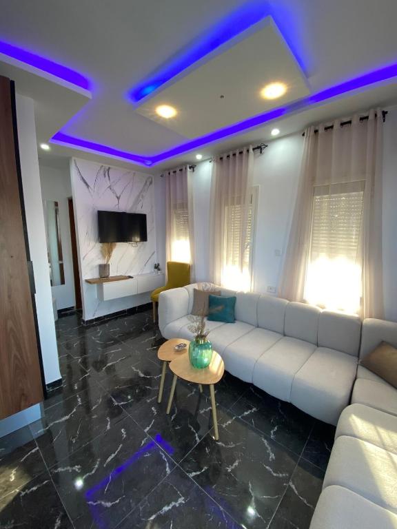 a living room with a white couch and a table at Green Oasis in Bou Ficha