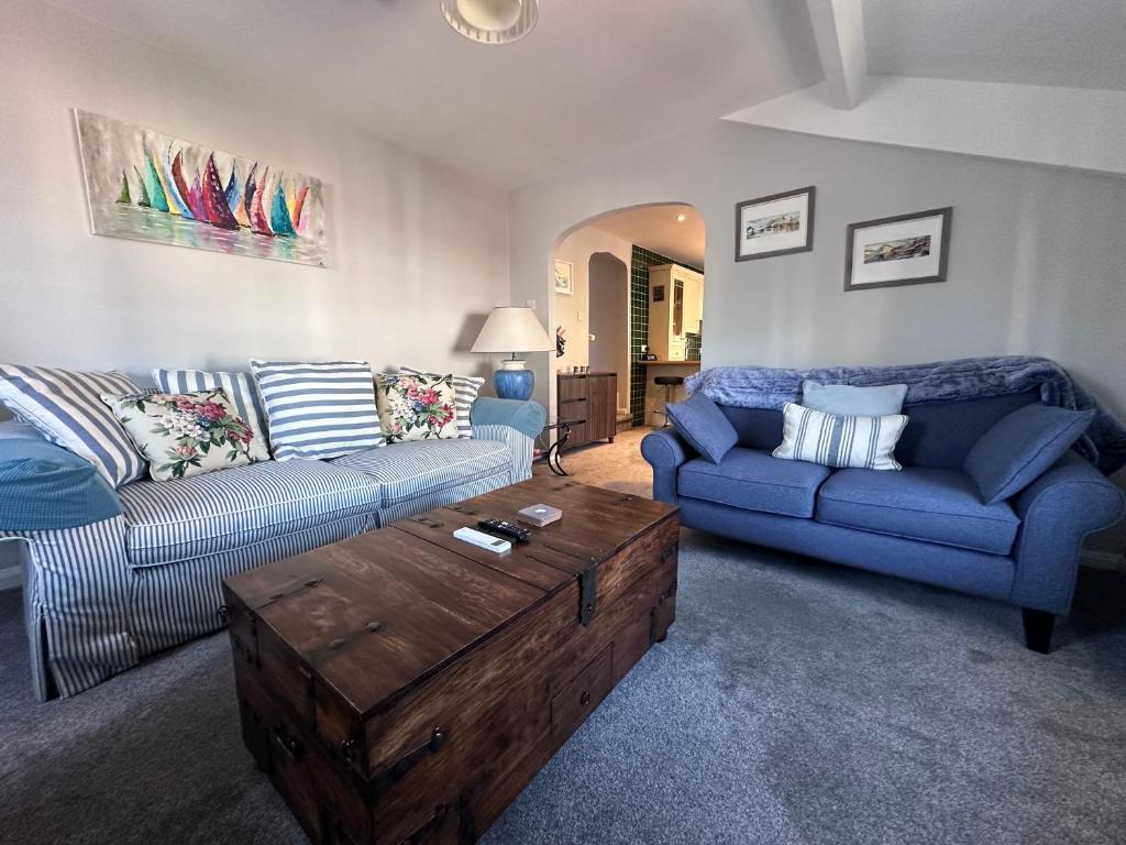 a living room with a couch and a coffee table at Eagle Cottage in Penrith