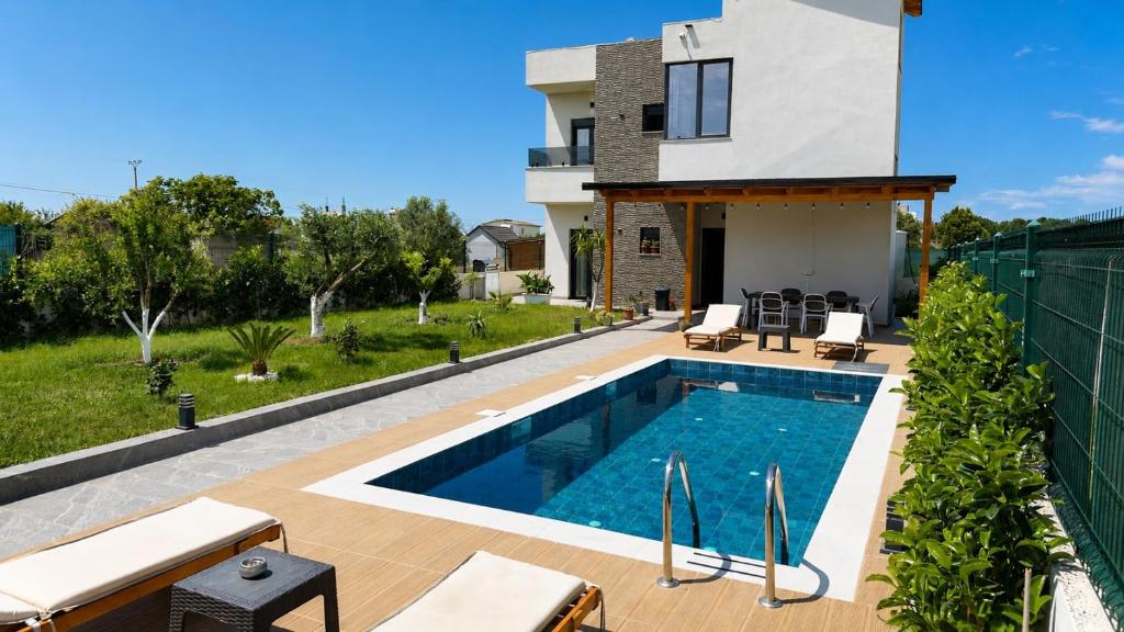 a villa with a swimming pool and a house at Julis Villa in Draç