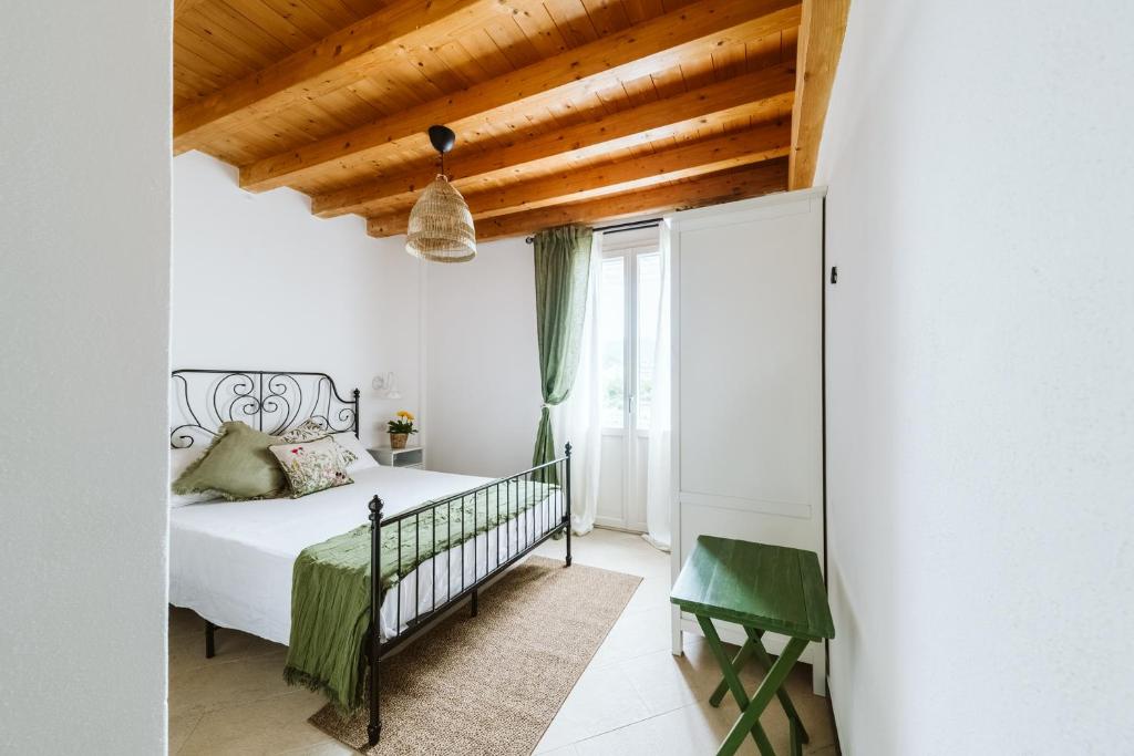 a bedroom with a bed and a wooden ceiling at Casa Rucola in Sestri Levante