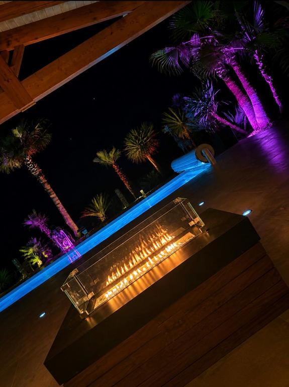 a bench with lights on a balcony at night at Luxury home private duras in Duras
