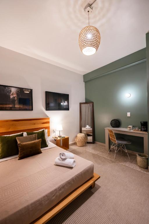 a bedroom with a large bed and a desk at Casa Origen in Oaxaca City