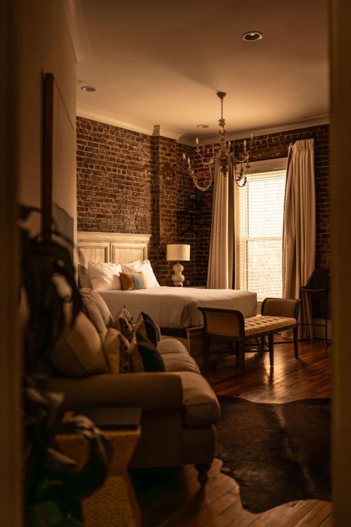 a bedroom with a bed and a couch in a room at The Luxe Loft Knoxville in Knoxville