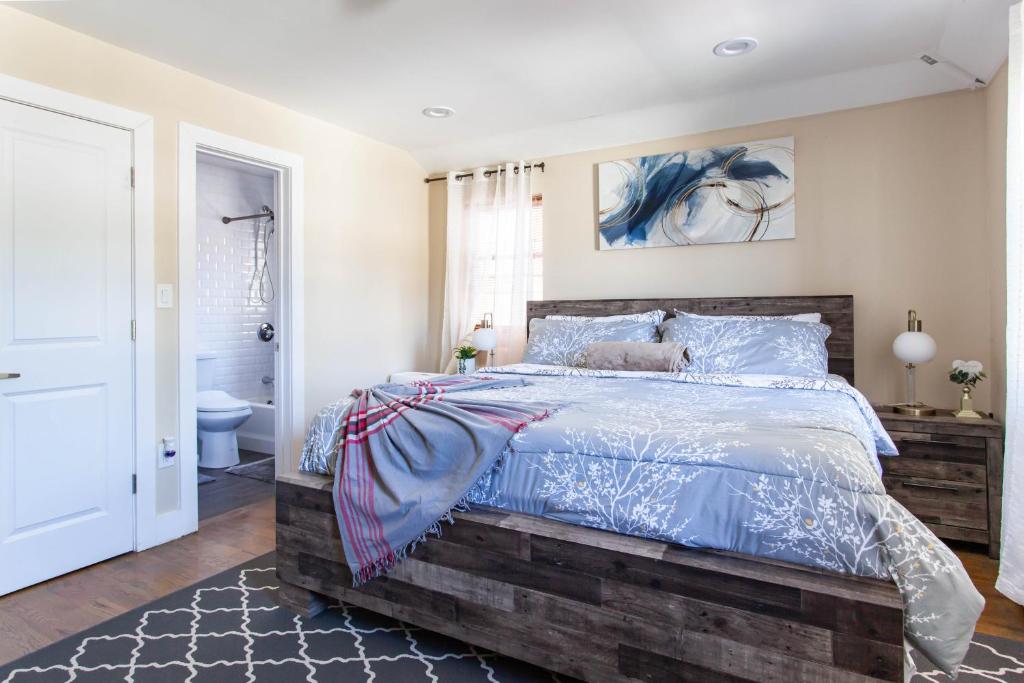 a bedroom with a large bed and a bathroom at Tonel Paradise in Rosedale
