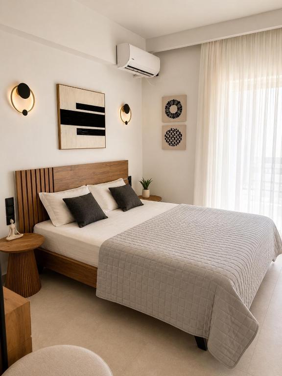 a bedroom with a large bed and a window at Studios Prodromidis Πρεβεζα in Preveza