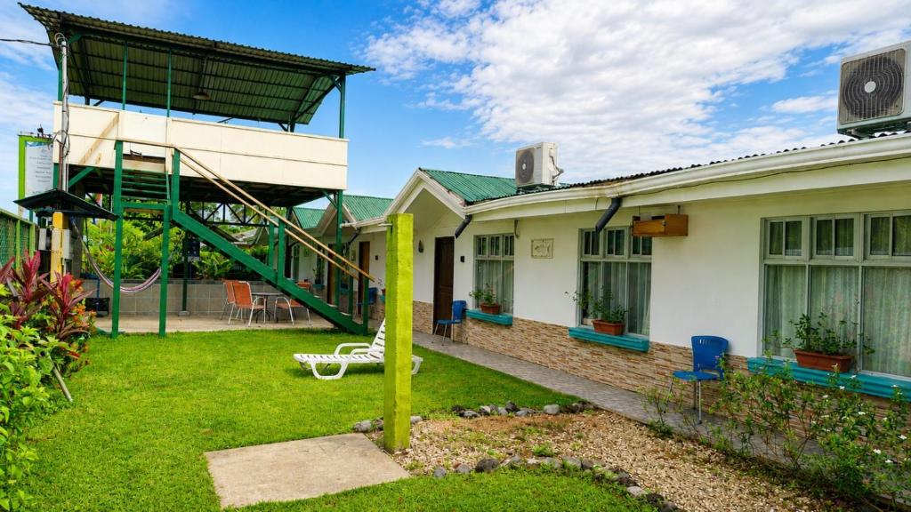 a house with a playground in the yard at Tropical Haus CR - El Manglar in Puerto Jiménez