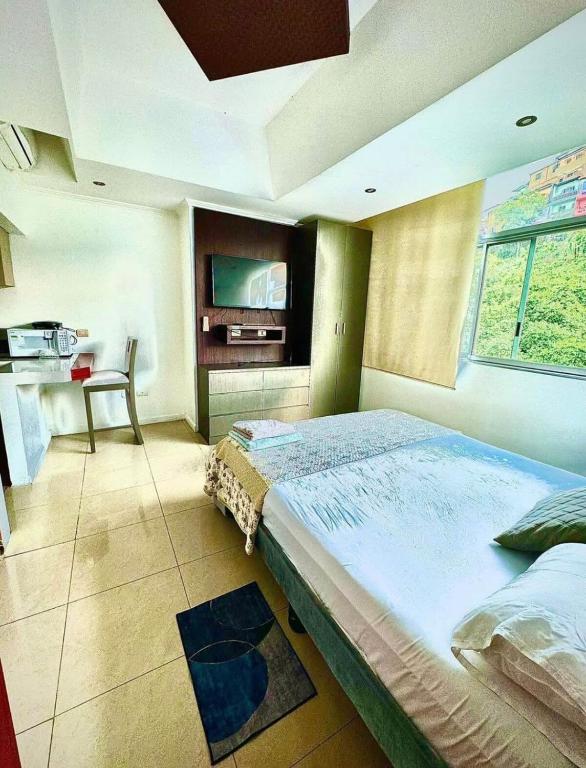 a bedroom with a large bed and a table in it at lighthouse view piso 8 in Guayaquil