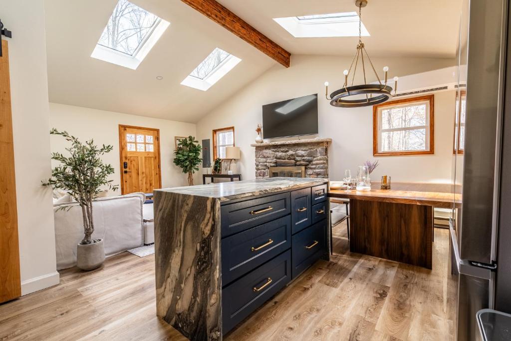 a kitchen with a blue island in the middle at Modern Designed Cabin with Secluded Backyard Firepit Grill Nintendo Switch2 in Gouldsboro