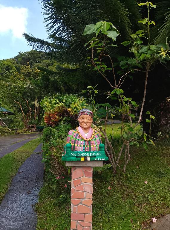 a statue of a woman on a brick pillar at Kaiche in Trafalgar