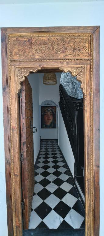 an entrance to a hallway with a checkered floor at Dar Mounia Les Oudayas in Rabat