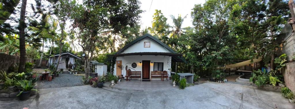a small house in a yard with trees at Sotera and Paz Forestville in Silang
