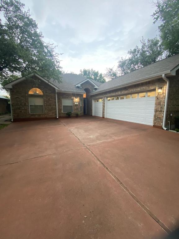 a house with a driveway and a garage at Delaware Springs Home in Burnet