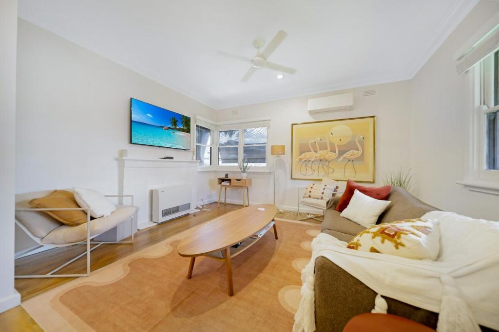 a living room with a couch and a table at The Ironbark Nest in Bendigo