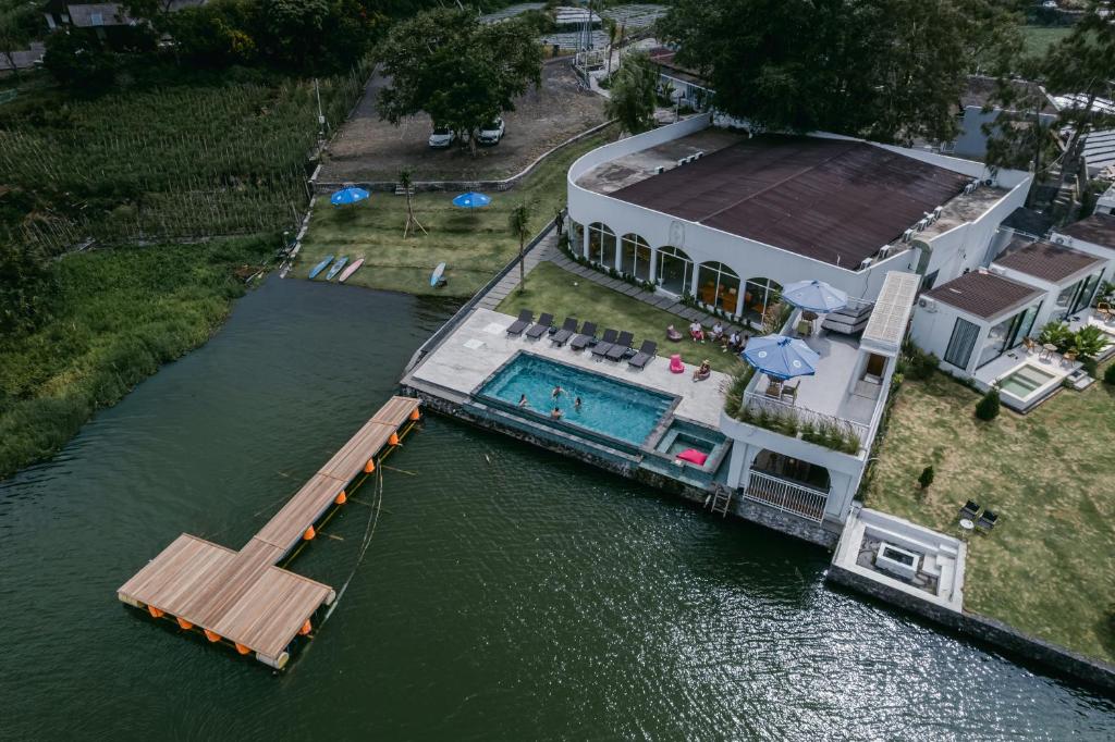 an aerial view of a house in the water at Lushy Kintamani in Kubupenlokan