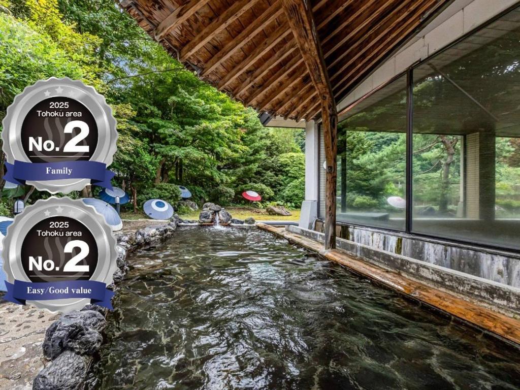 a pool of water outside of a house at KAMENOI HOTEL Akita Yuze in Kazuno