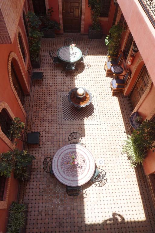 an overhead view of a courtyard with tables and chairs at Riad Afriquia Garden in Marrakesh
